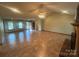 Open living room showcasing tile floors, high ceilings, fireplace, and outdoor access at 6339 River Front Dr, Harrisburg, NC 28075