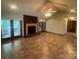 Bright living room with brick fireplace and large format tile floors at 6339 River Front Dr, Harrisburg, NC 28075
