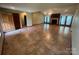 Open-concept living room with fireplace, tile flooring, and natural light at 6339 River Front Dr, Harrisburg, NC 28075