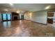 Spacious living room with fireplace, tile flooring, and sunroom access at 6339 River Front Dr, Harrisburg, NC 28075