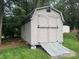 Large backyard shed with double doors and a ramp, perfect for storage at 6339 River Front Dr, Harrisburg, NC 28075