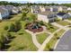 Aerial view of a community playground with slides surrounded by homes, landscaping, and walking paths at 7318 Rupell Dr, Charlotte, NC 28273