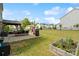 Large backyard with a wood fired grill, dining, patio and garden bed at 7318 Rupell Dr, Charlotte, NC 28273