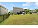 Spacious fenced backyard with lush green grass, patio, and grill at 7318 Rupell Dr, Charlotte, NC 28273