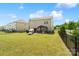 Well-maintained backyard with spacious lawn, patio, grill, and dark iron fence at 7318 Rupell Dr, Charlotte, NC 28273