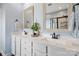 Bright bathroom features dual sinks, white cabinetry, marble countertop, and modern fixtures at 7318 Rupell Dr, Charlotte, NC 28273