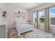 Charming bedroom features a white bed and large window with cheerful décor at 7318 Rupell Dr, Charlotte, NC 28273