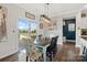 Bright dining area with a sliding glass door, stylish light fixture, and a rustic table with decorative chairs at 7318 Rupell Dr, Charlotte, NC 28273