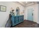 Inviting foyer with a stylish cabinet, decorative mirror, and a light blue door at 7318 Rupell Dr, Charlotte, NC 28273