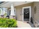 Close-up of the front door with a welcoming wreath, sidelight window, and stone-accented porch column at 7318 Rupell Dr, Charlotte, NC 28273