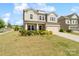 Charming two-story home with a well-manicured lawn, lovely landscaping, and a welcoming front porch at 7318 Rupell Dr, Charlotte, NC 28273