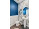 Stylish half bathroom with floral wallpaper, wainscoting, pedestal sink, and a round mirror at 7318 Rupell Dr, Charlotte, NC 28273