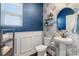 Stylish half bathroom with floral wallpaper, wainscoting, pedestal sink, and a round mirror at 7318 Rupell Dr, Charlotte, NC 28273