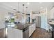 Bright open-concept kitchen with a large island, stainless steel appliances, and adjacent dining area at 7318 Rupell Dr, Charlotte, NC 28273