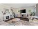 Cozy living room with a fireplace, staircase, and a stylish rug over dark hardwood flooring at 7318 Rupell Dr, Charlotte, NC 28273