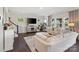 Comfortable living room with a plush sofa, large TV, and ample natural light from multiple windows at 7318 Rupell Dr, Charlotte, NC 28273
