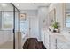 Bright main bathroom with double vanity, soaking tub, and glass-enclosed shower for a spa-like experience at 7318 Rupell Dr, Charlotte, NC 28273