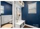 Charming mudroom with built-in bench, hooks, and storage shelves, complemented by blue walls and wainscoting at 7318 Rupell Dr, Charlotte, NC 28273