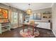 Bright home office featuring a wooden desk, custom curtains, and a built-in storage unit at 7318 Rupell Dr, Charlotte, NC 28273