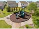 Community playground with slides and play structures, surrounded by lush green landscaping and walking paths at 7318 Rupell Dr, Charlotte, NC 28273