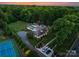 Majestic estate with manicured lawns, a sparkling pool, tennis court, and a grand driveway leading to the home at 8300 Fairview Rd, Charlotte, NC 28226