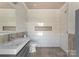 The stylish bathroom features modern fixtures and a unique pebble floor at 8300 Fairview Rd, Charlotte, NC 28226