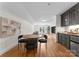 Entertainers bonus room featuring a dining area, full wet bar, and living room with a comfy couch at 8300 Fairview Rd, Charlotte, NC 28226