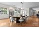 Dining room with hardwood floors, large mirror, bright windows, and contemporary lighting at 8300 Fairview Rd, Charlotte, NC 28226