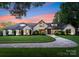 Elegant home with a well-manicured lawn and a circular driveway showcasing its classic architectural design at 8300 Fairview Rd, Charlotte, NC 28226