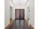Spacious foyer with dark wood floors, a modern chandelier, and views into multiple rooms at 8300 Fairview Rd, Charlotte, NC 28226