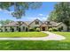 Stately home with lush landscaping and a circular driveway, showcasing curb appeal and architectural charm at 8300 Fairview Rd, Charlotte, NC 28226