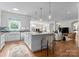 Open-concept kitchen with an island, stylish pendant lighting, stainless appliances, and hardwood floors at 8300 Fairview Rd, Charlotte, NC 28226