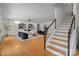 Spacious living room with hardwood floors, modern staircase, stylish furnishings, and striking contemporary artwork at 8300 Fairview Rd, Charlotte, NC 28226