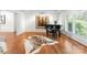 Living room features piano, zebra hide rug, crown molding, and an abundance of natural light at 8300 Fairview Rd, Charlotte, NC 28226