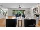 Bright living room featuring glass slider doors to backyard pool and outdoor area at 8300 Fairview Rd, Charlotte, NC 28226