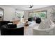 Bright living room with hardwood floors, black and white furniture, and sliding glass doors to the backyard at 8300 Fairview Rd, Charlotte, NC 28226