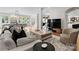 Comfortable living room with hardwood floors, stylish furnishings, and a large television for entertainment at 8300 Fairview Rd, Charlotte, NC 28226