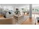 Open-concept living room featuring hardwood floors, a modern fireplace, and seamless flow to the dining and kitchen areas at 8300 Fairview Rd, Charlotte, NC 28226
