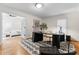 Office features a black desk, modern art, hardwood floors, and a view into the bedroom at 8300 Fairview Rd, Charlotte, NC 28226
