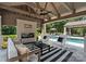 Outdoor living area with a fireplace and comfortable seating offers an inviting retreat at 8300 Fairview Rd, Charlotte, NC 28226