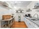 Walk-in pantry with shelves, storage for appliances, utility sink and countertop, featuring convenient organization at 8300 Fairview Rd, Charlotte, NC 28226