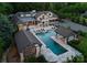 Aerial view of an exquisite backyard with a large pool, spa, cabanas, outdoor bar, and entertainment area at 8300 Fairview Rd, Charlotte, NC 28226