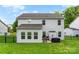 Two-story home exterior with gray siding, a large backyard, and an outdoor patio at 865 Wingthorn Rose Dr, Gastonia, NC 28056