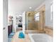 Bathroom featuring a shower, soaking tub, tile surround, dual sink vanity, and access to the main bedroom at 865 Wingthorn Rose Dr, Gastonia, NC 28056