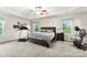 The primary bedroom featuring exercise equipment, tray ceiling, and generous natural light at 865 Wingthorn Rose Dr, Gastonia, NC 28056