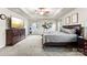 Spacious bedroom with carpet, tray ceiling, large bed, dresser, and a television set for relaxing entertainment at 865 Wingthorn Rose Dr, Gastonia, NC 28056