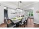 Elegant dining room with modern chandelier, table setting and gray dining chairs at 865 Wingthorn Rose Dr, Gastonia, NC 28056