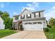 View of the home's front exterior, showcasing the driveway and manicured landscaping at 865 Wingthorn Rose Dr, Gastonia, NC 28056
