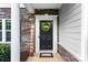 Close-up of the front door with a 'Welcome' sign and a decorative wreath at 865 Wingthorn Rose Dr, Gastonia, NC 28056