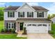 Charming two-story home featuring gray siding, stone accents, and a well-maintained front yard at 865 Wingthorn Rose Dr, Gastonia, NC 28056